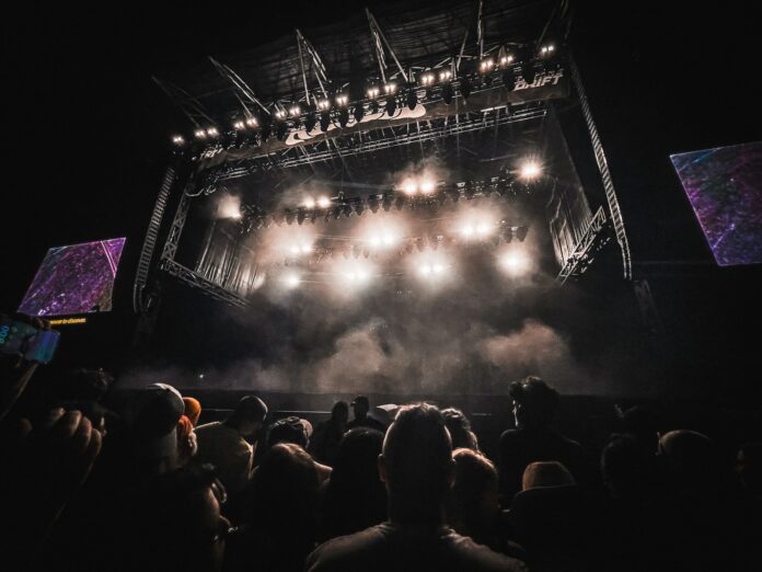 A crowd of people watching a concert on stage
