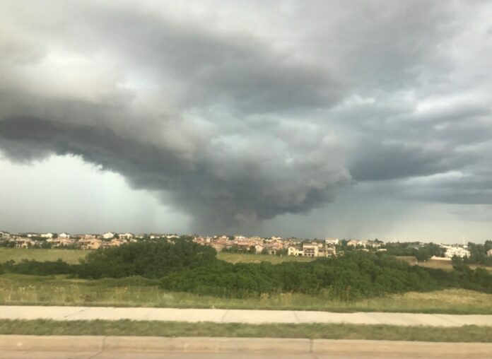a large storm cloud is seen over a city