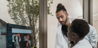 a few men looking at a computer screen
