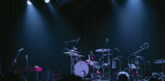 A band playing on stage in front of a crowd
