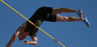 man in black tank top and black shorts doing push up