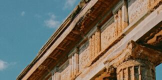 a statue of a man standing next to a building
