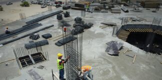 a group of men standing on top of a construction site