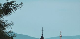 a large white building with a black roof