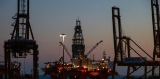 red and black metal tower during sunset
