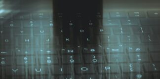 A computer keyboard with a sky background