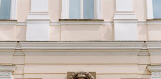 brown wooden door on white concrete building