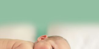 baby lying on fabric cloth