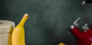 yellow banana fruit on brown wooden chopping board