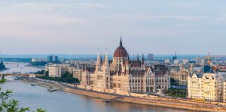 brown concrete building near body of water during daytime