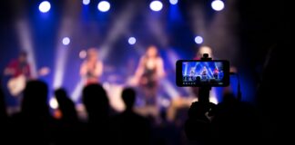people taking videos during concert