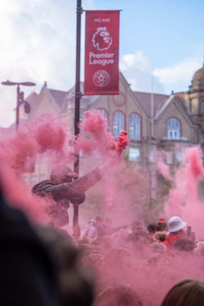 a crowd of people with colored powder in the air