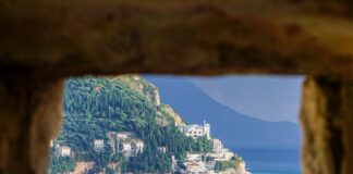 brown concrete building near body of water during daytime