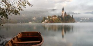 brown wooden boat floating on body of water