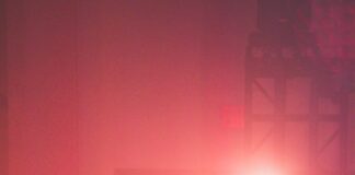 red drum set besides microphone stands