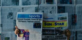 a person sitting on a newspaper