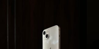 a white iphone sitting on top of a black table