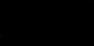 Vertical illuminated hotel sign at night