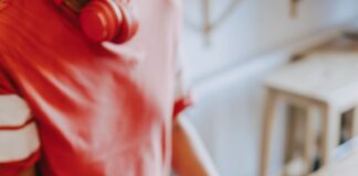 two person's hands holding turned-on phones