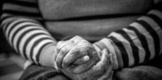 grayscale photography of sitting person