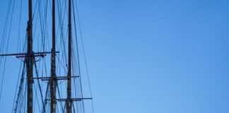 a boat is docked in front of a large building