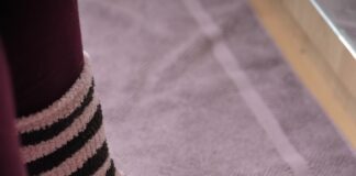 person wearing white bedroom slippers