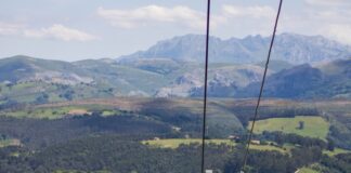 brown metal tower on green grass field during daytime