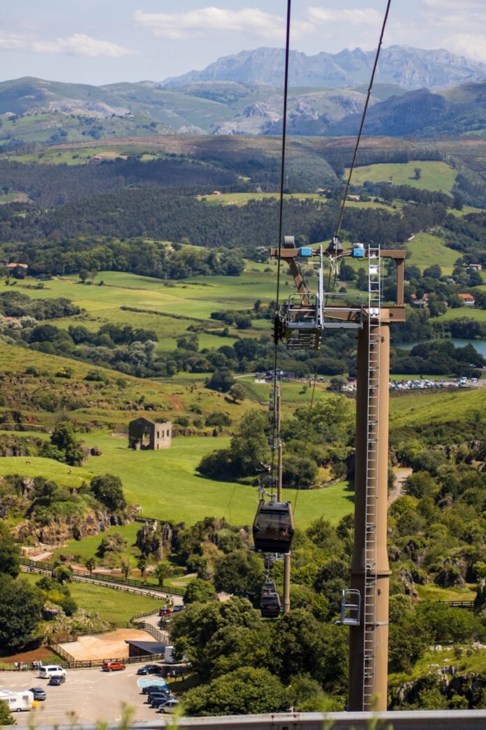 brown metal tower on green grass field during daytime
