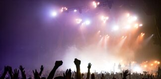 crowd facing lighted stage