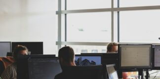 people sitting on chair in front of computer monitor