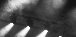a black and white photo of a stage with lights