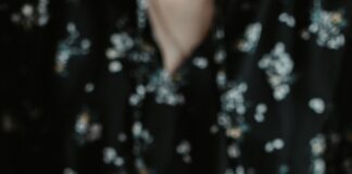 a person holding a plate with rolls on it