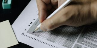 person writing on white paper