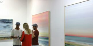 man in red and white long sleeve shirt standing beside woman in white long sleeve shirt