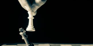 grayscale photo of person holding glass