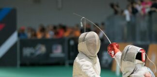 two person fencing inside the gym