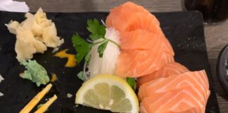 salmon fish near sliced lemon, noodles, and parsley