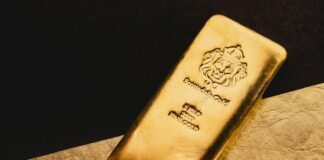 a gold bar sitting on top of a piece of paper