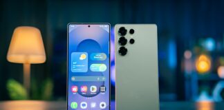 A cell phone sitting on top of a table next to a lamp