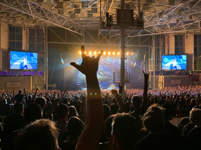 a large crowd of people watching a concert