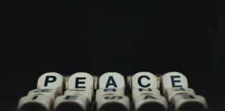 a group of dices with the words peace written on them