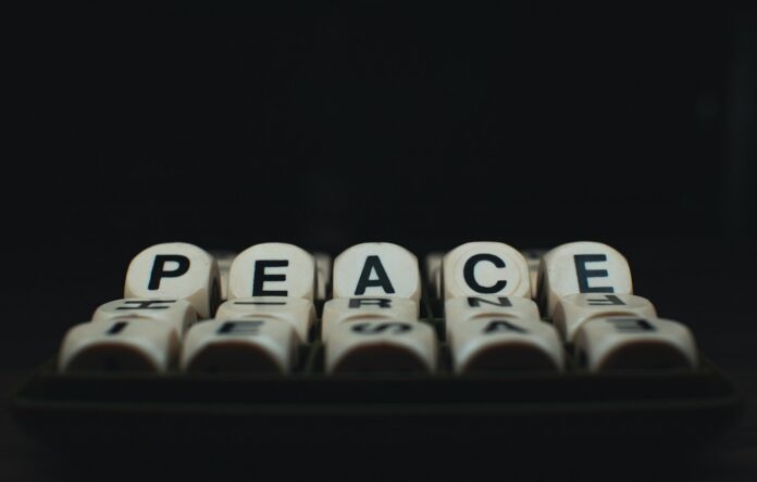 a group of dices with the words peace written on them