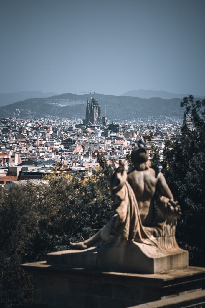 a view of a city with a statue in the foreground