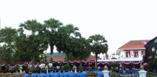A group of men in blue uniforms standing in front of a crowd