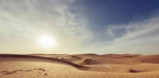gray sand under white and blue sky