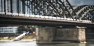 man in gray suit standing near body of water during daytime