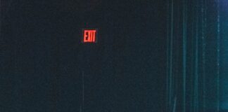 a group of people sitting in a dark auditorium