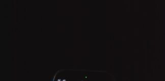 a cell phone sitting on top of a laptop computer