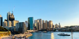 people walking on the beach near high rise buildings during daytime