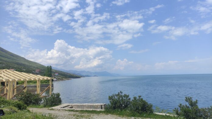 a body of water with a dock and a building by it